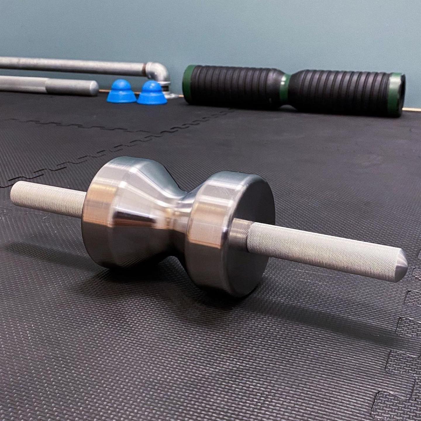 Iron Pillow solid steel body tempering tool on gym floor mats